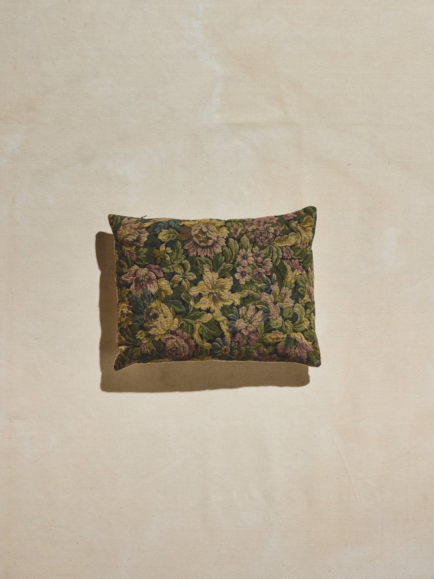 Bayou bloom vintage floral lumbar pillow in green, blue, lilac, and ochre.