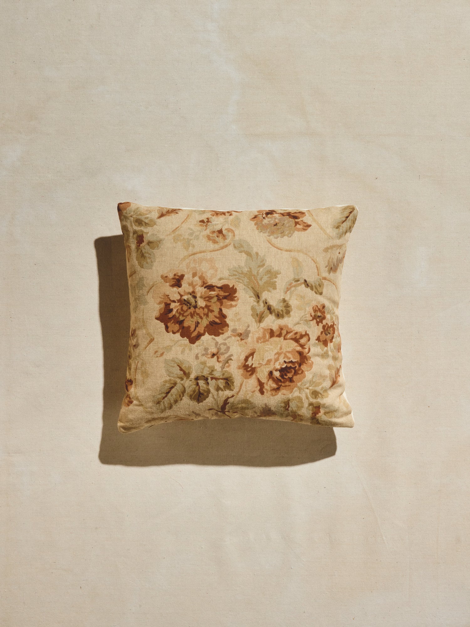 Warm pastels and rust hues floral patterned woven pillow.