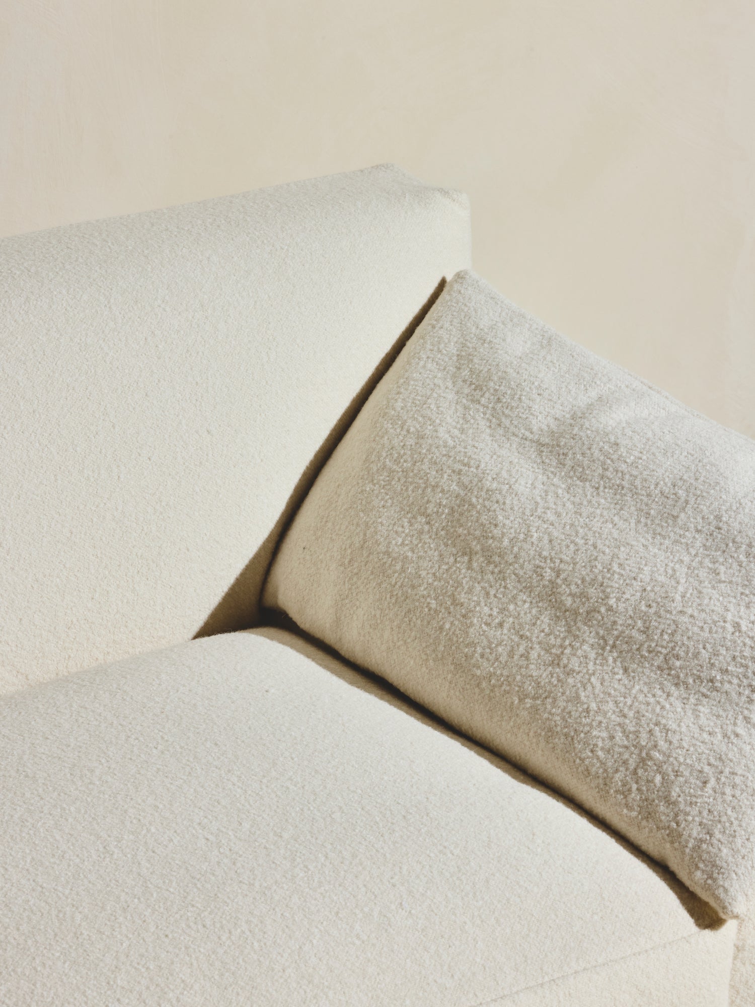 Close up of arm rest cushion on the Bromley Sofa in our crema fabric.