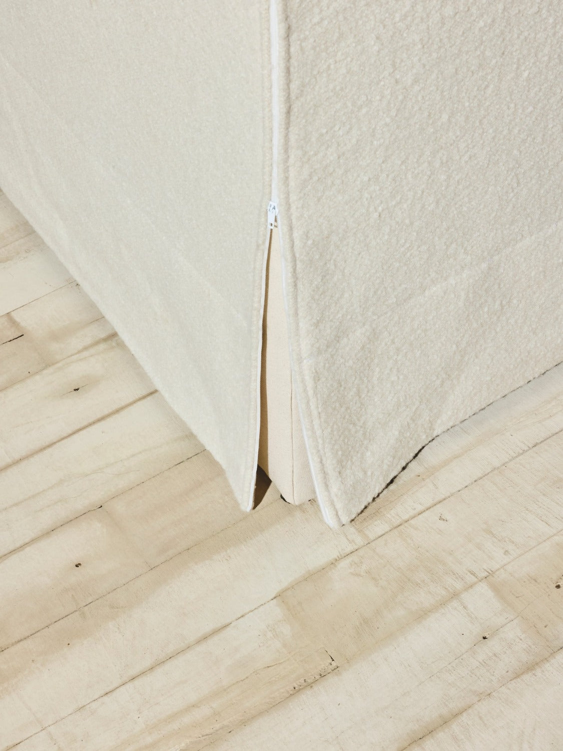 Close up of crema color slip cover on the Bromley Sofa.