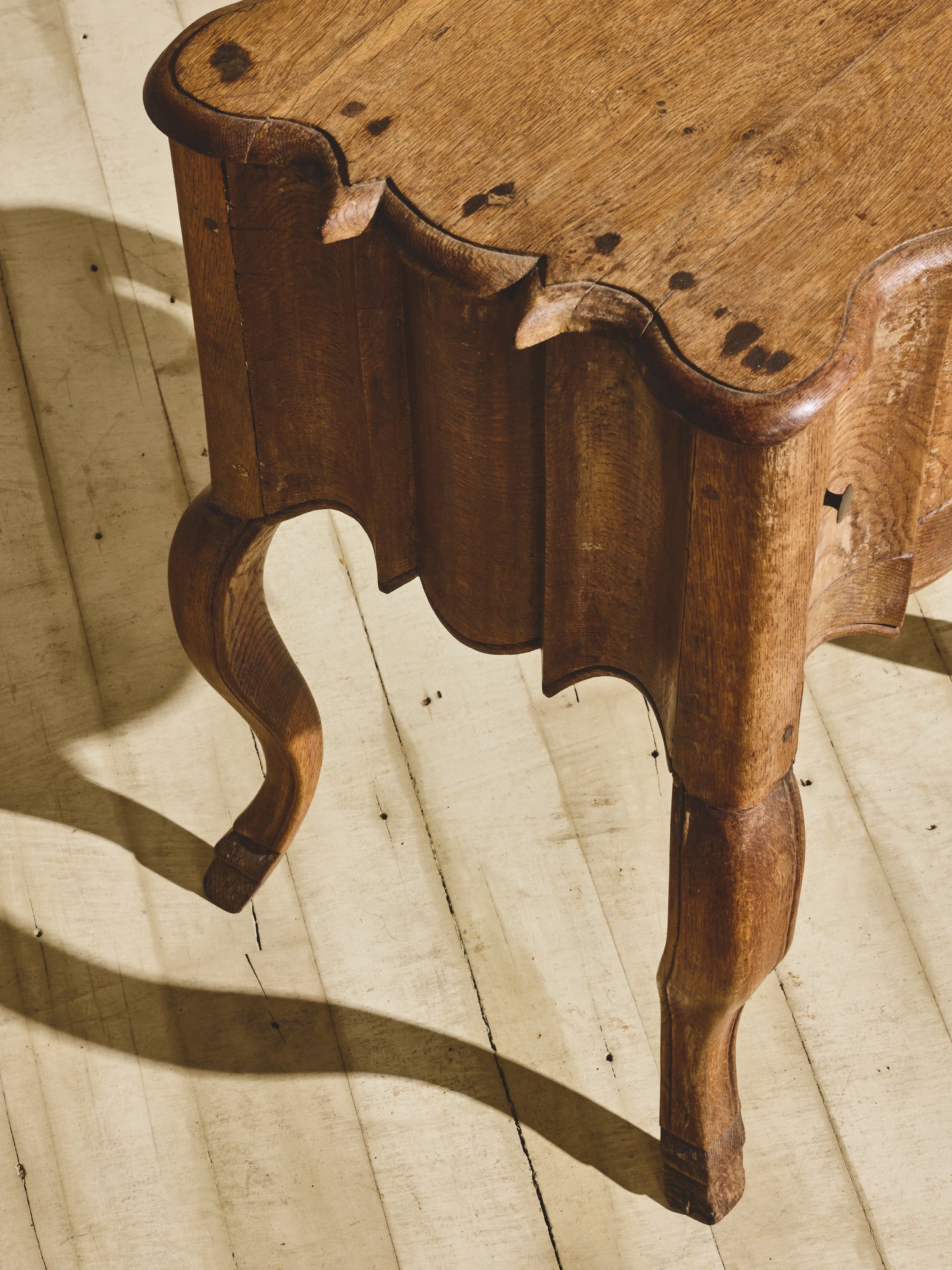 Baroque solid oak side table with fluted sides, wavy oak grain pattern, and hand sculpted XV French style legs.