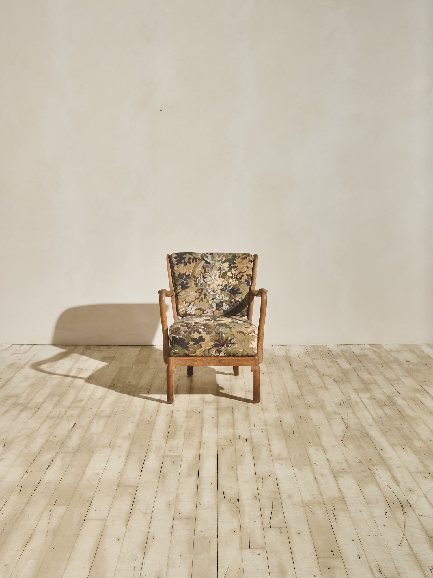 Alfred Christensen Chair with rounded armrests and a slatted back.