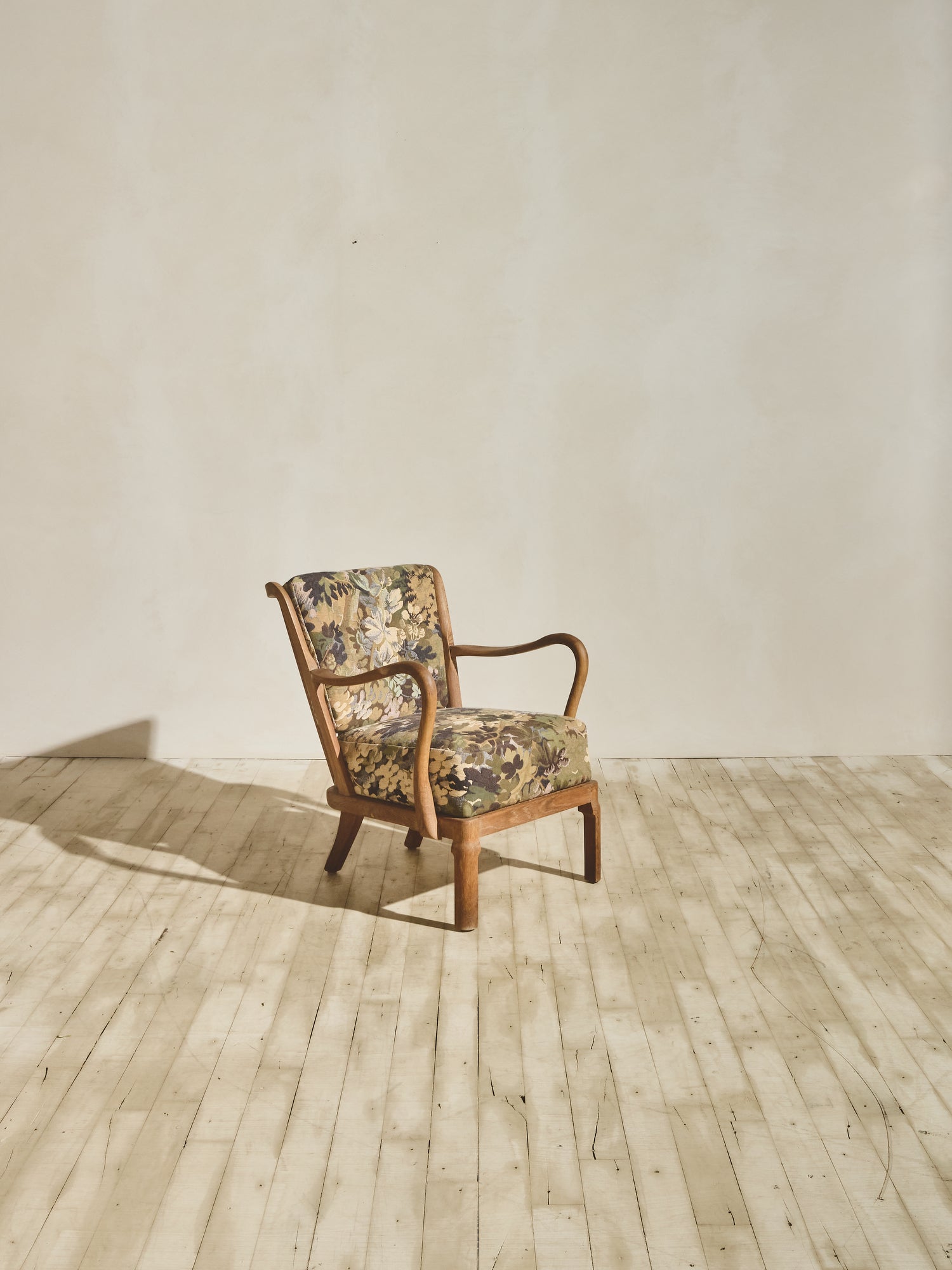 Alfred Christensen Chair with rounded armrests and a slatted back.