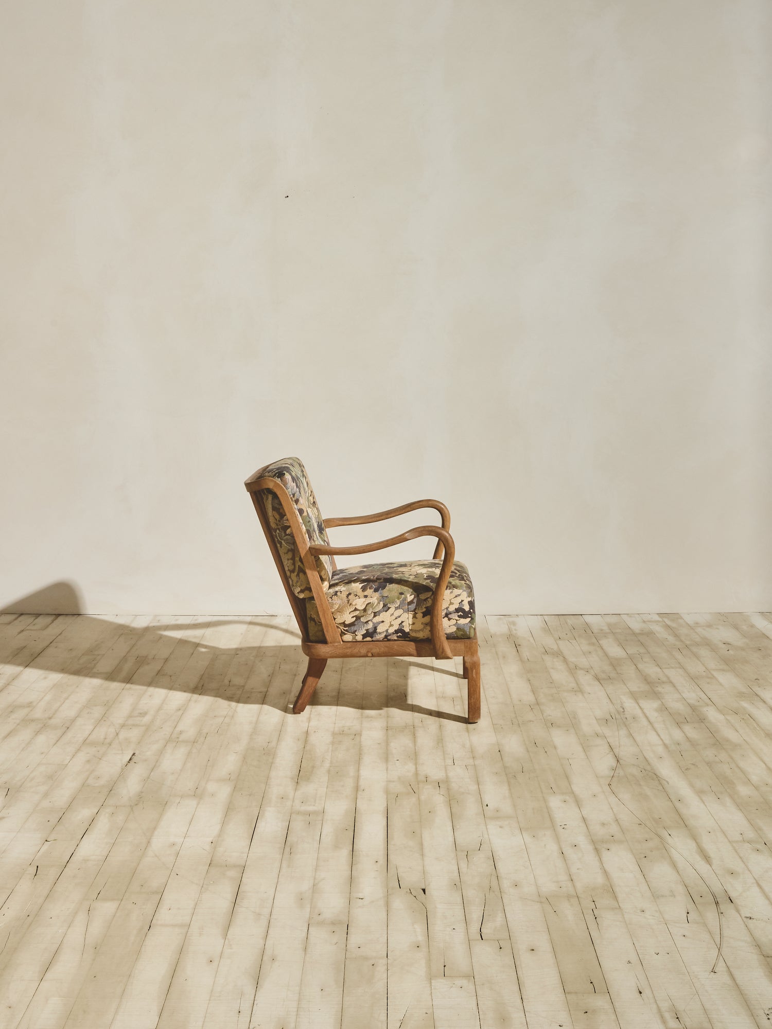 Alfred Christensen Chair with rounded armrests and a slatted back.