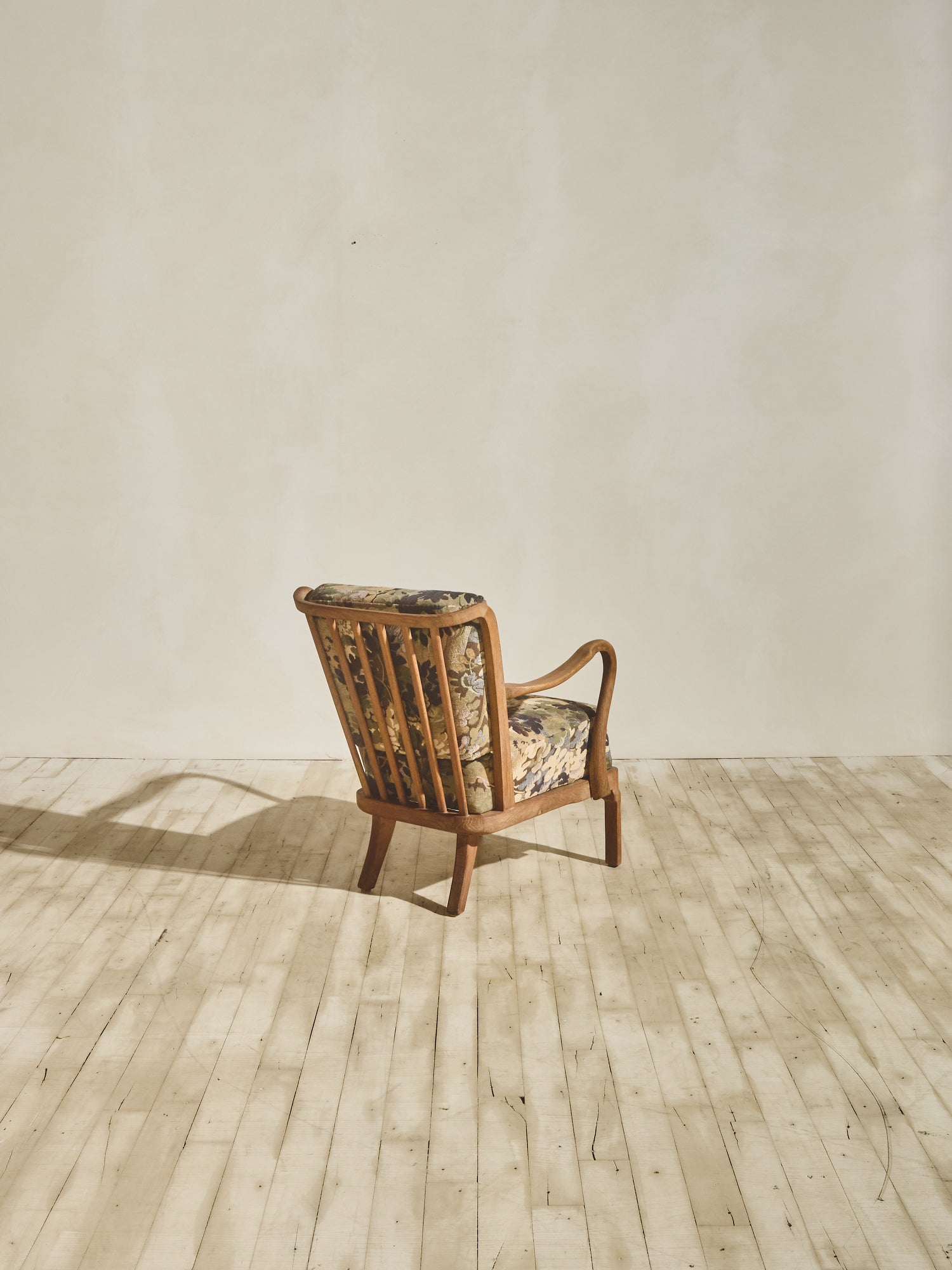 Alfred Christensen Chair with rounded armrests and a slatted back.