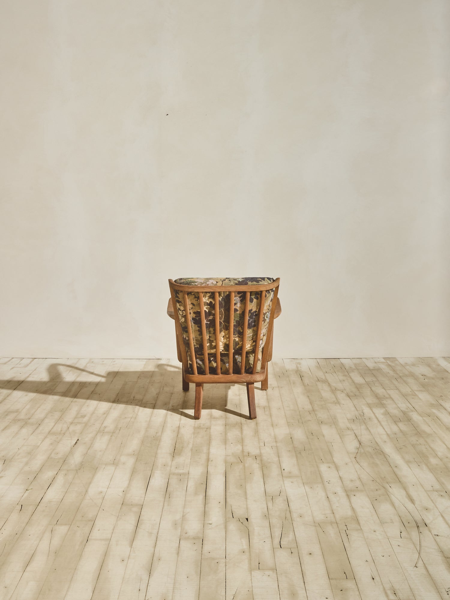 Alfred Christensen Chair with rounded armrests and a slatted back.