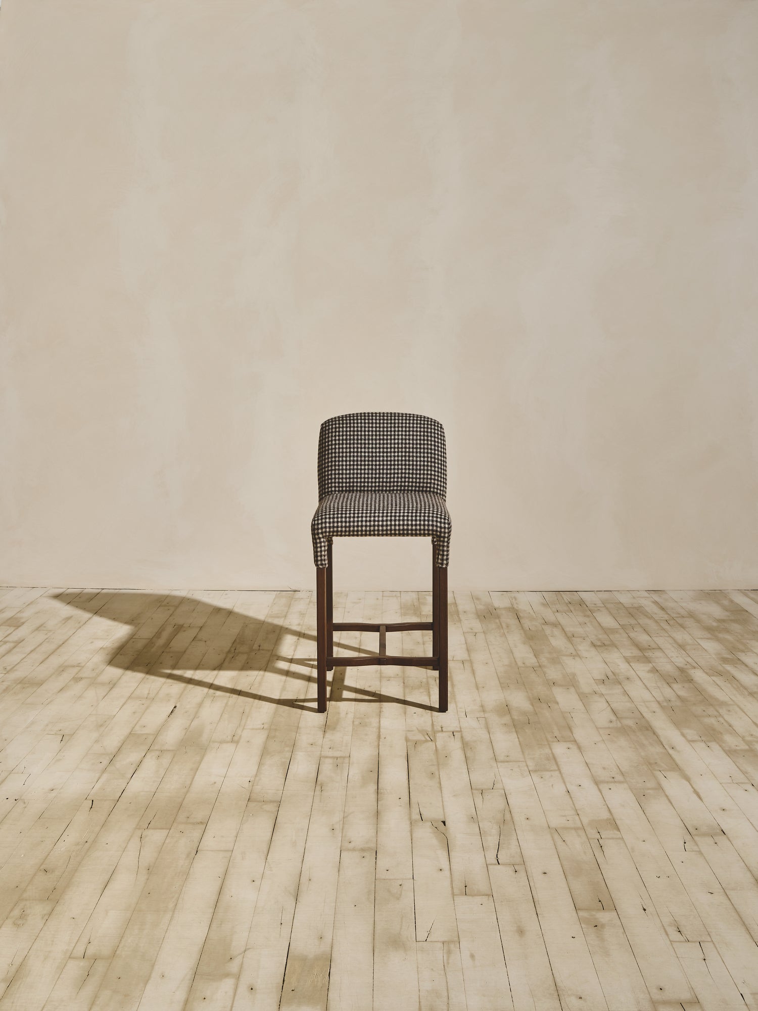 Heritage version of Mr. Wolcott curved back counter stool in natural finish and upholstered fabric seating.