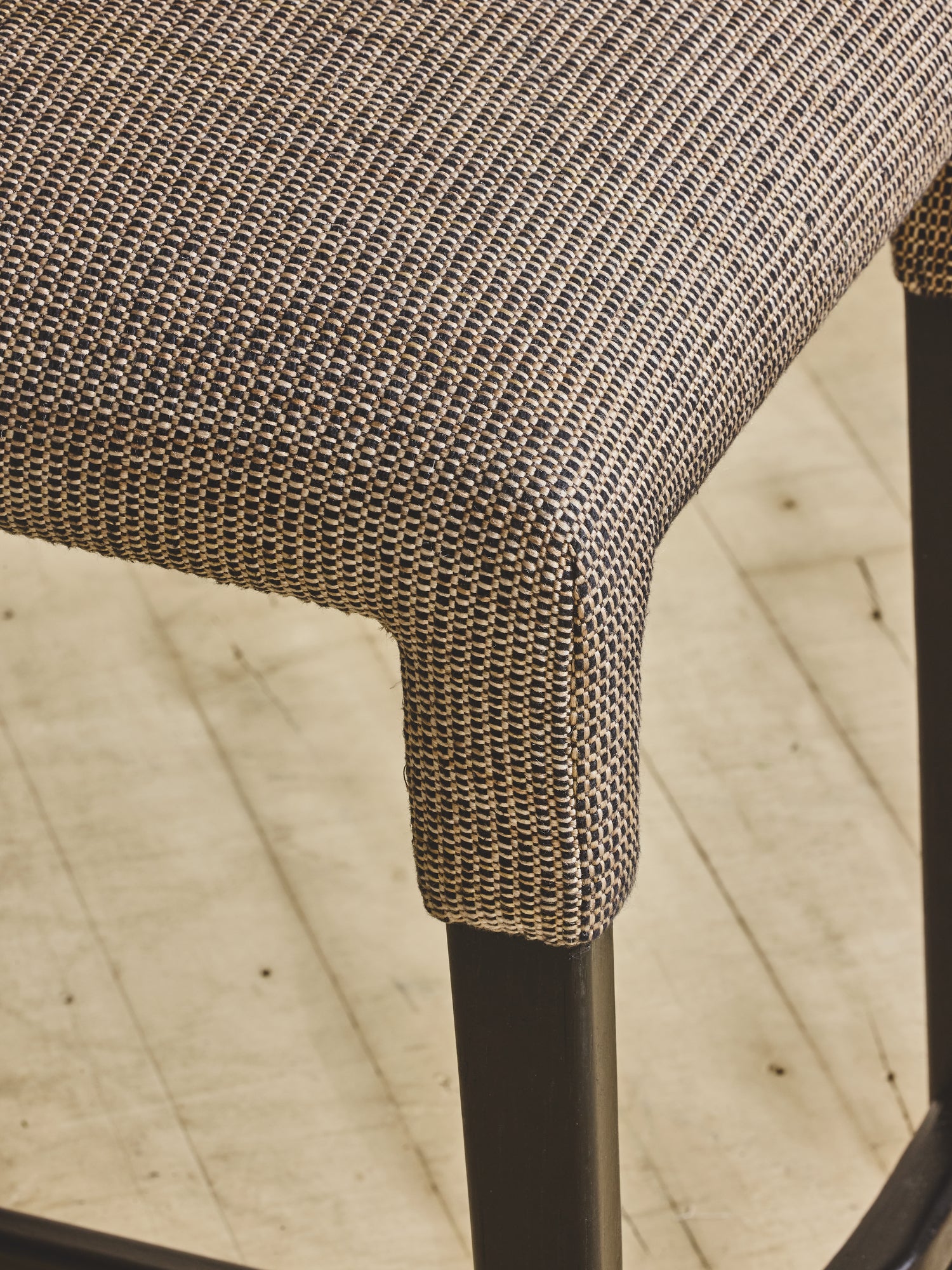 Close up of upholstered seating on the white oak Mr. Wolcott Counter Stool.