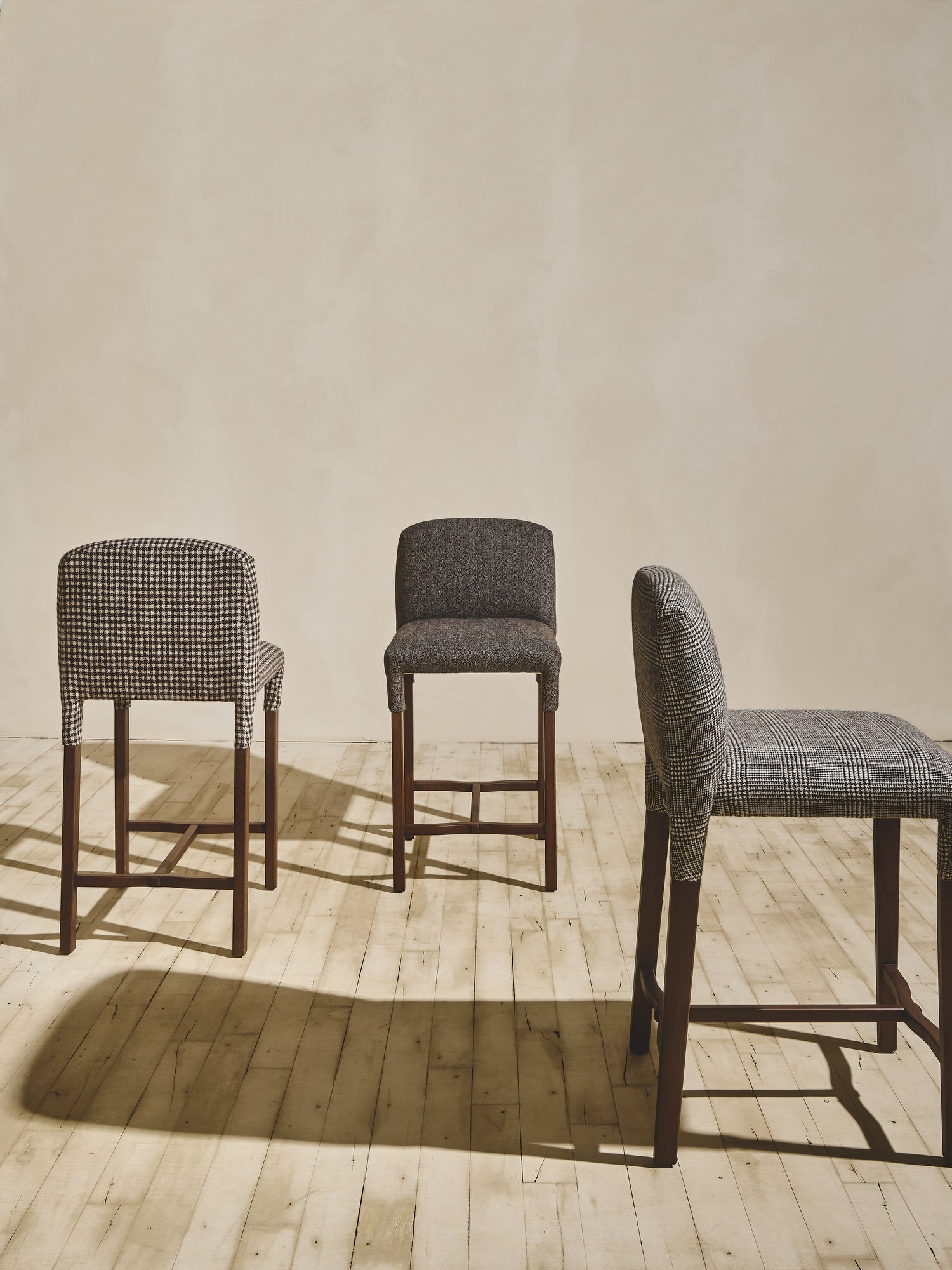 Group of heritage style Mr. Wolcott Counter Stool in natural finish and upholstered fabric seating.