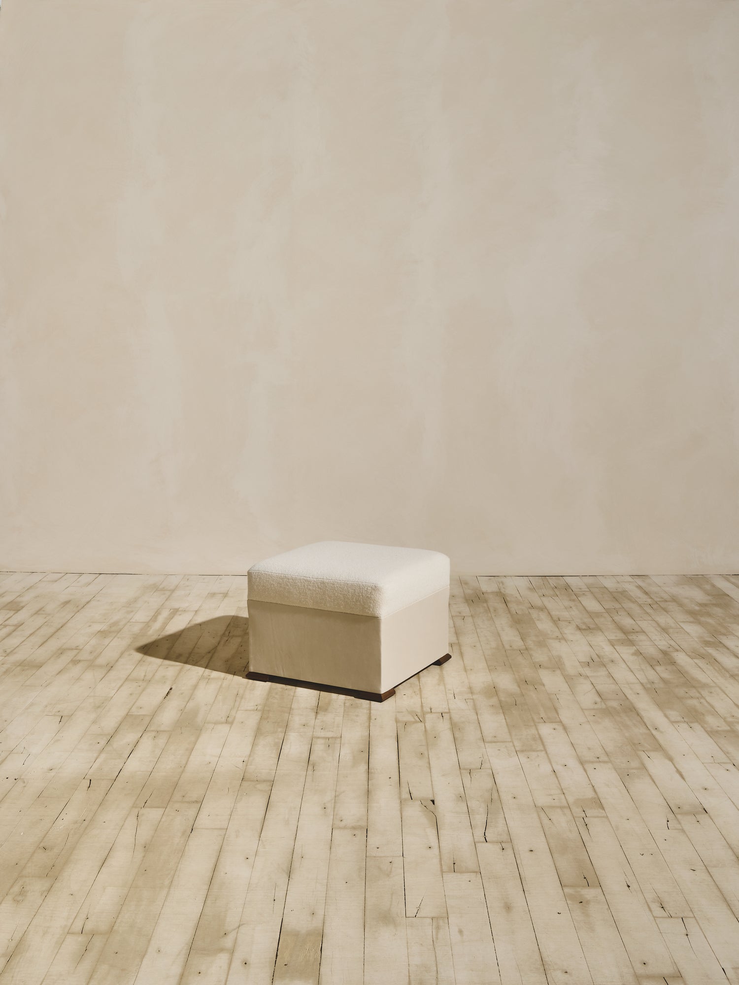 Brutalist style Bromley Ottoman in crema fabric.