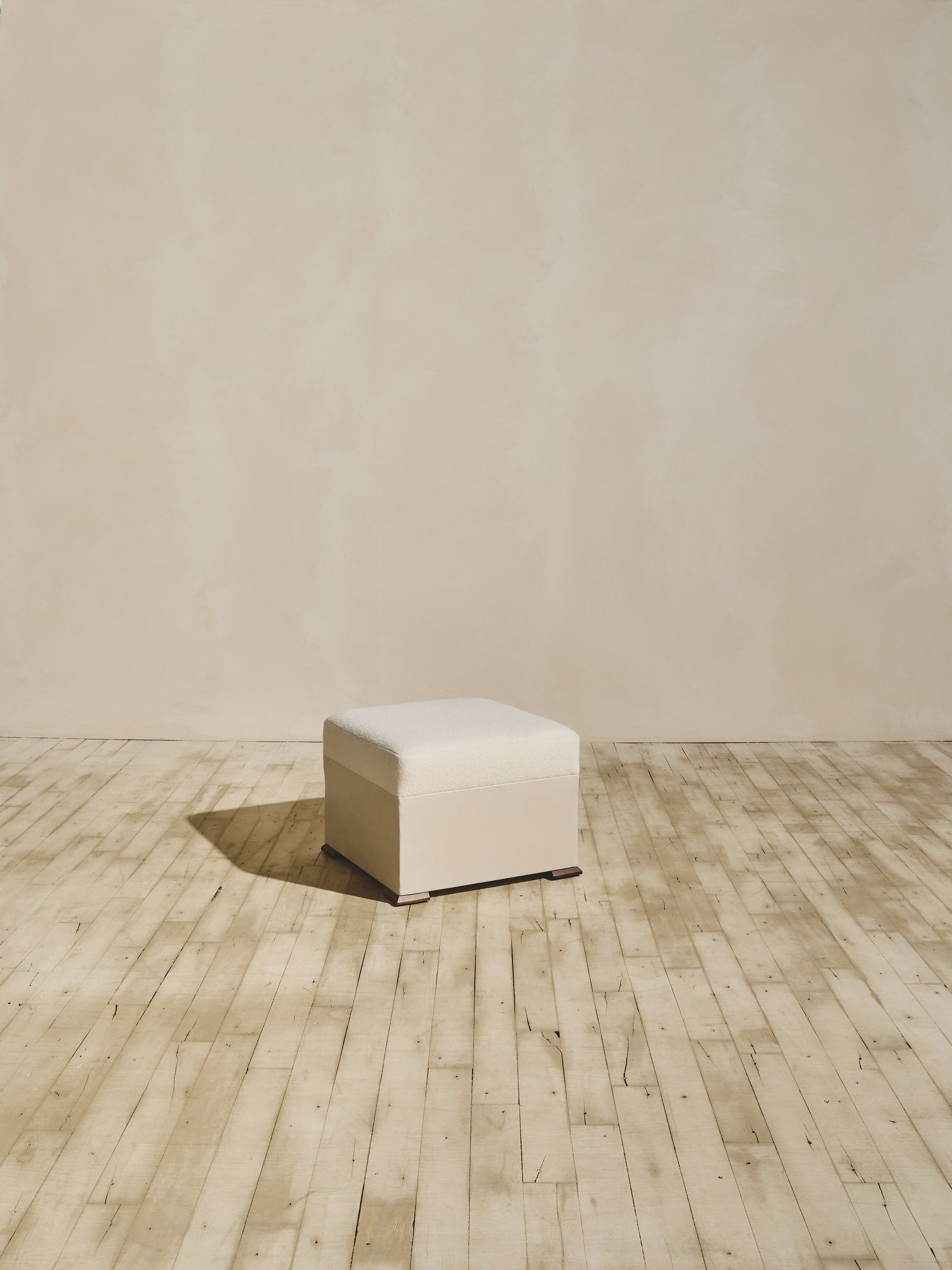 Brutalist style Bromley Ottoman in crema fabric.