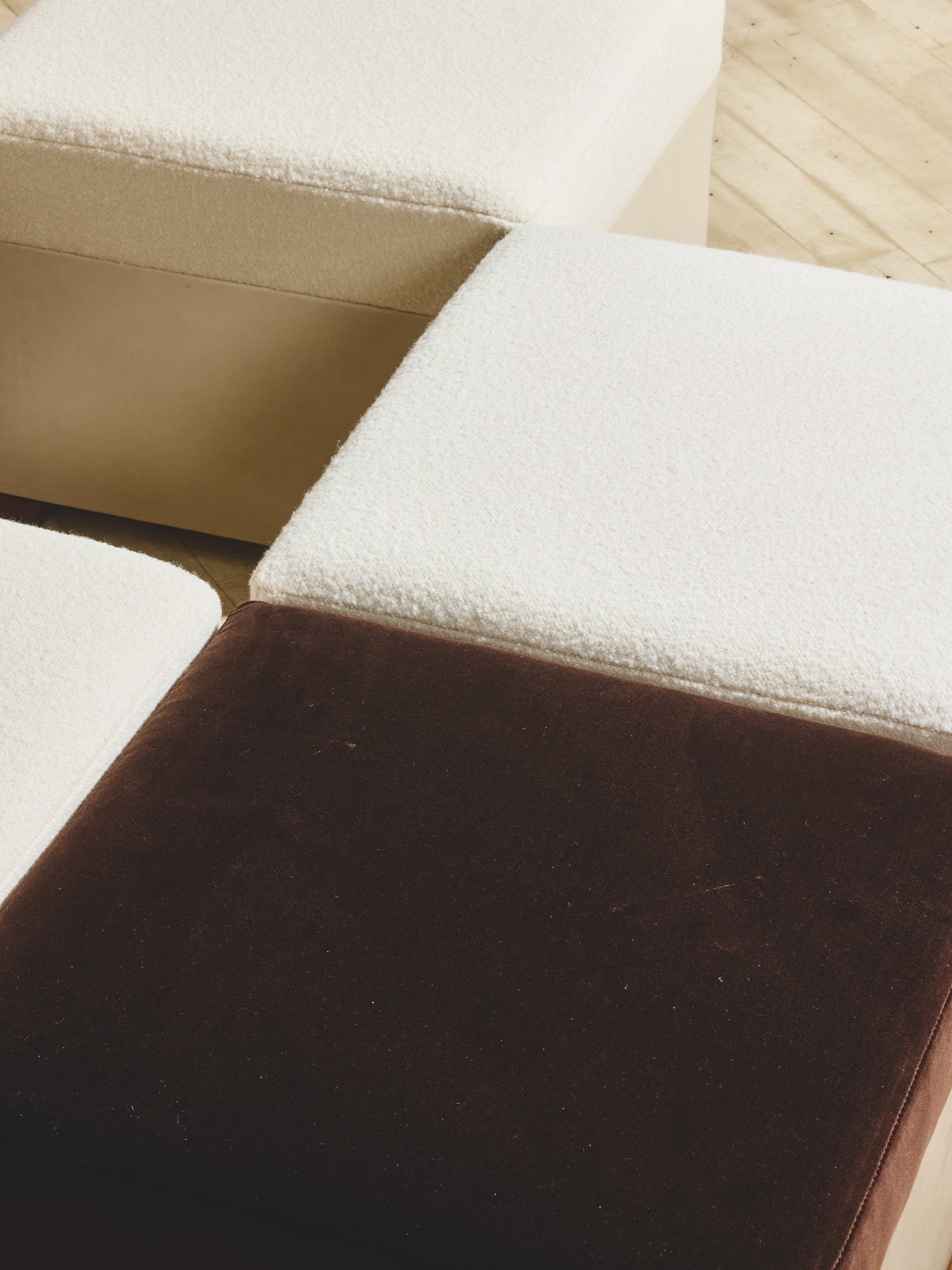 Close up of comfort seating on the Bromley Ottoman in crema/cigar fabric.