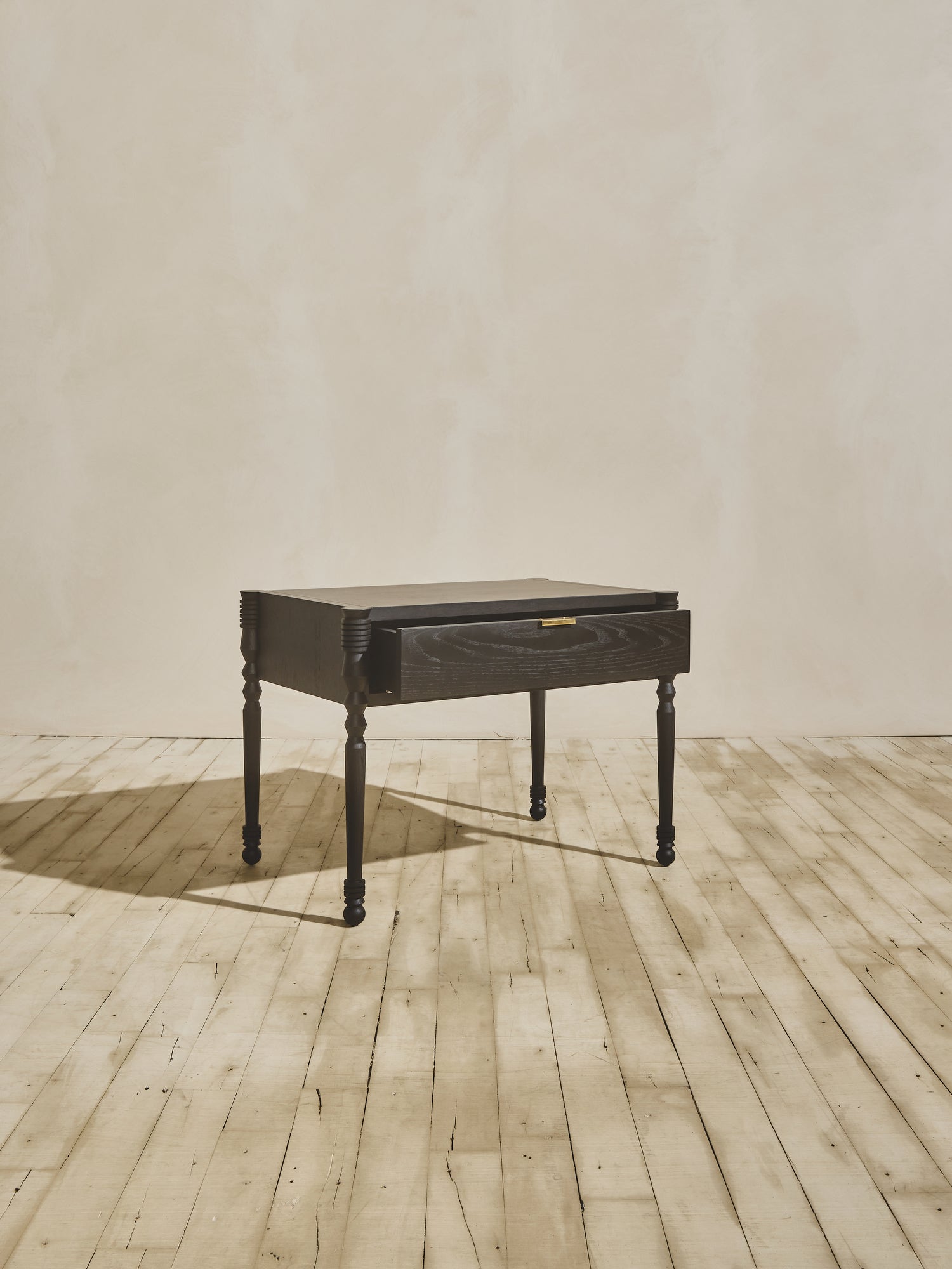 Side view of modern style wooden Disc Side Table with opened drawer, in ebony finish.