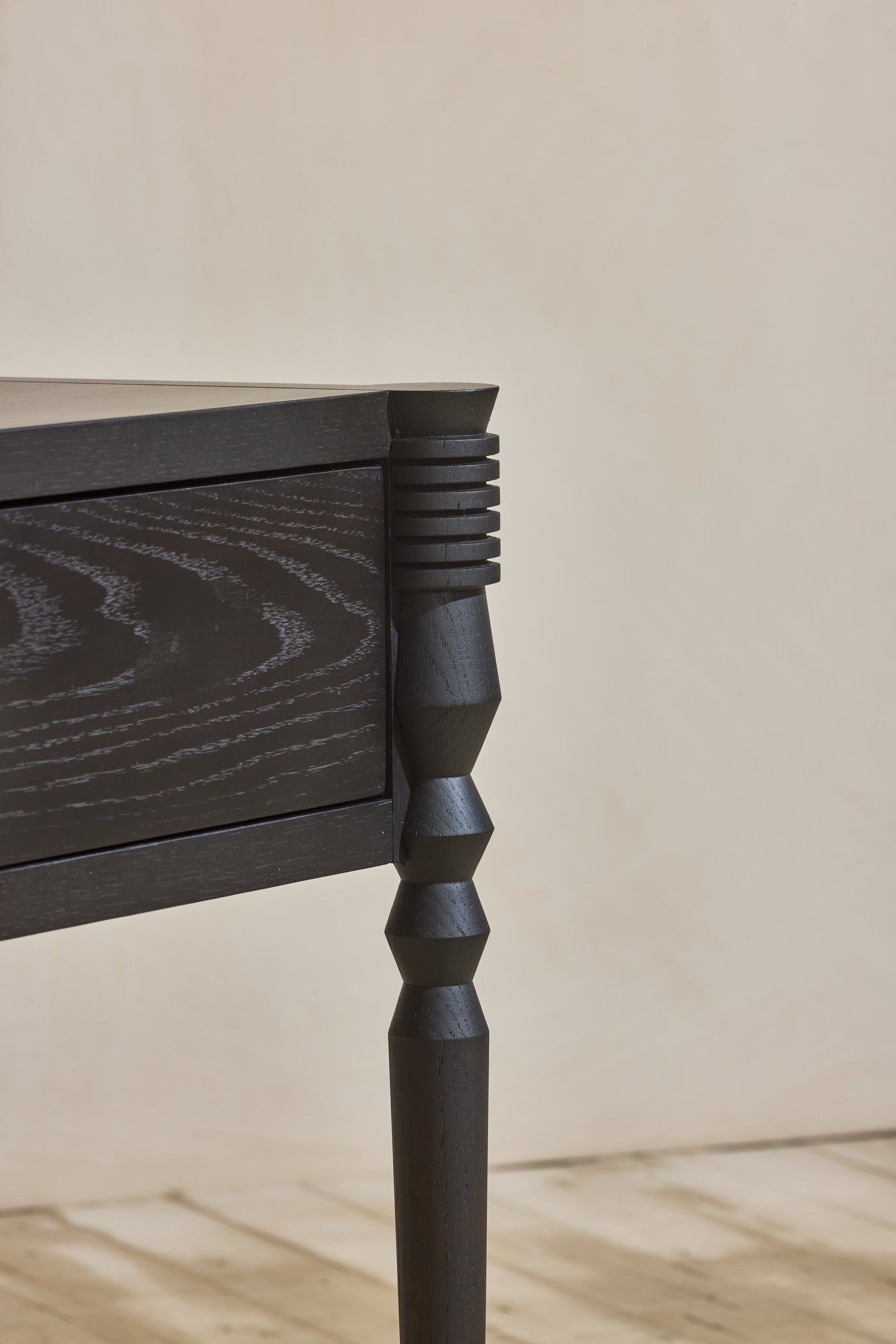 Close up of geometric leg turnings in ebony finish from Disc Side Table.