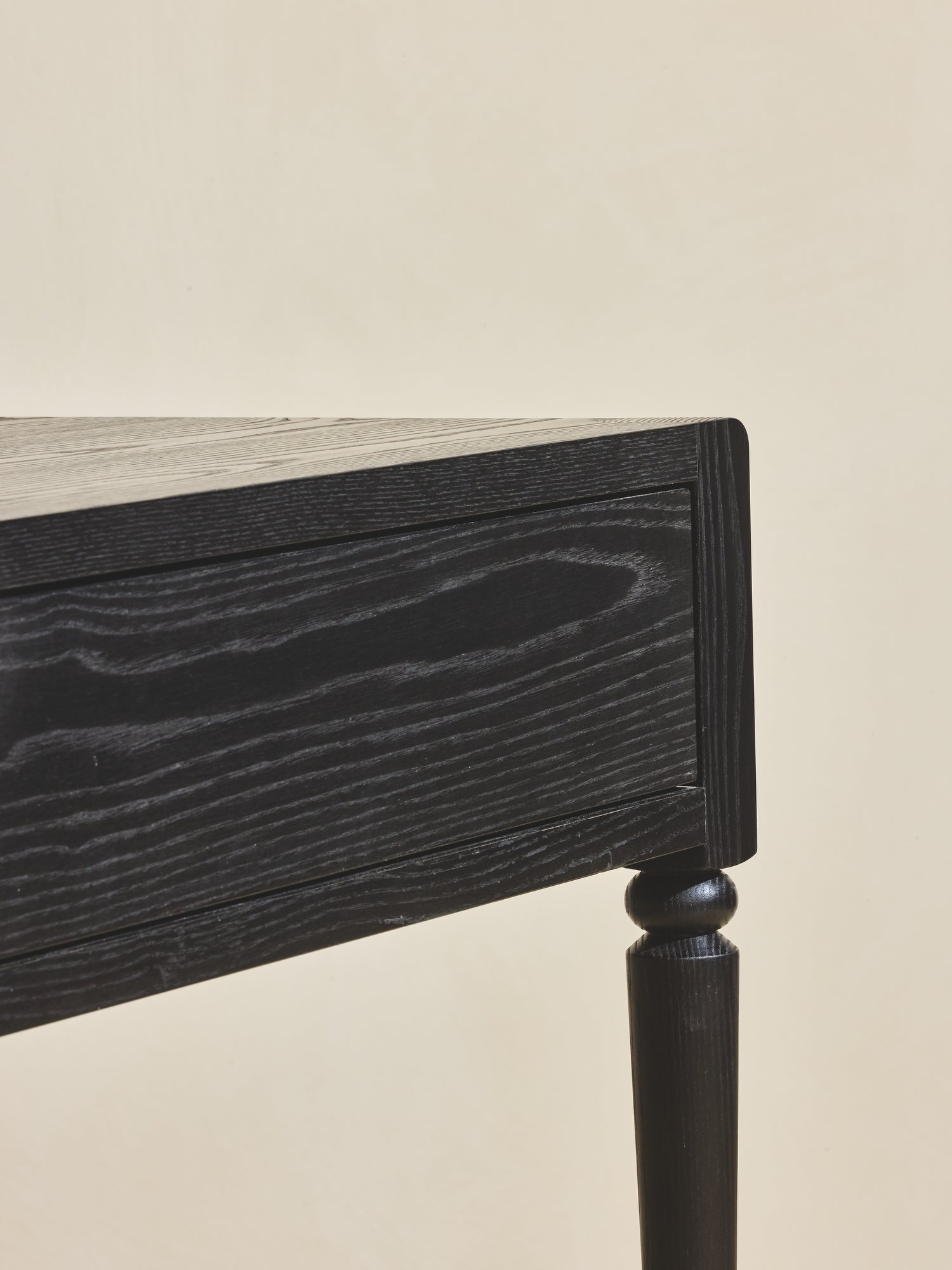 Close of up the oak wood grain in ebony finish on the Disc Desk.