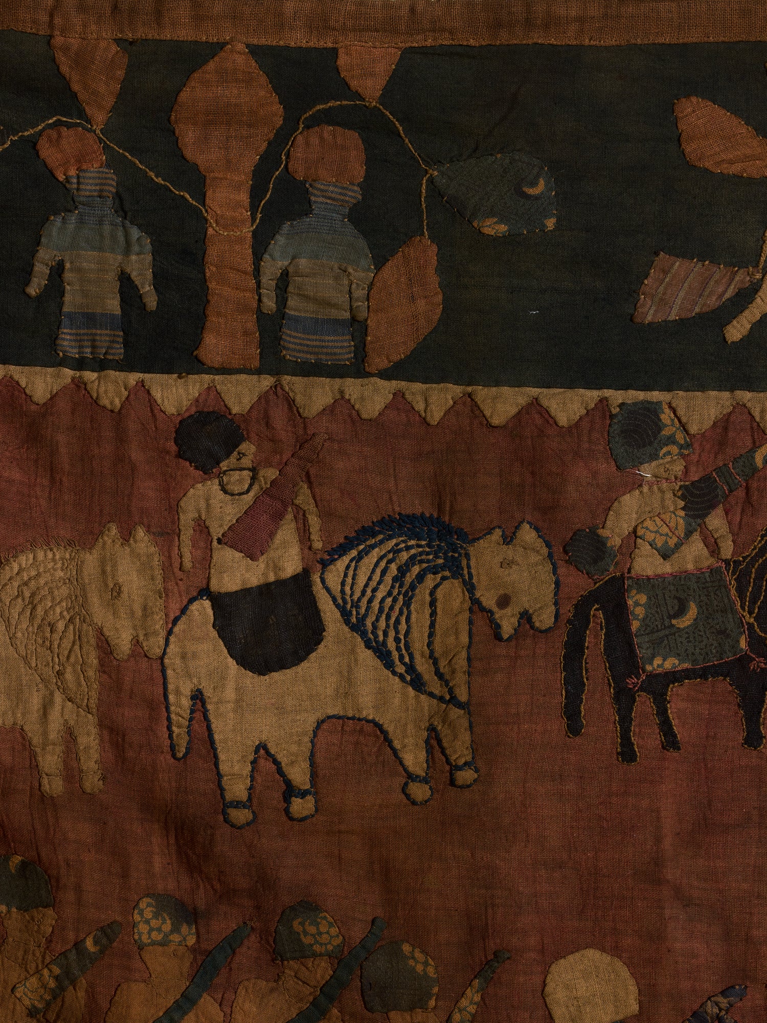 Quilted tribal tapestry, auburn, green, and yellow hues.
