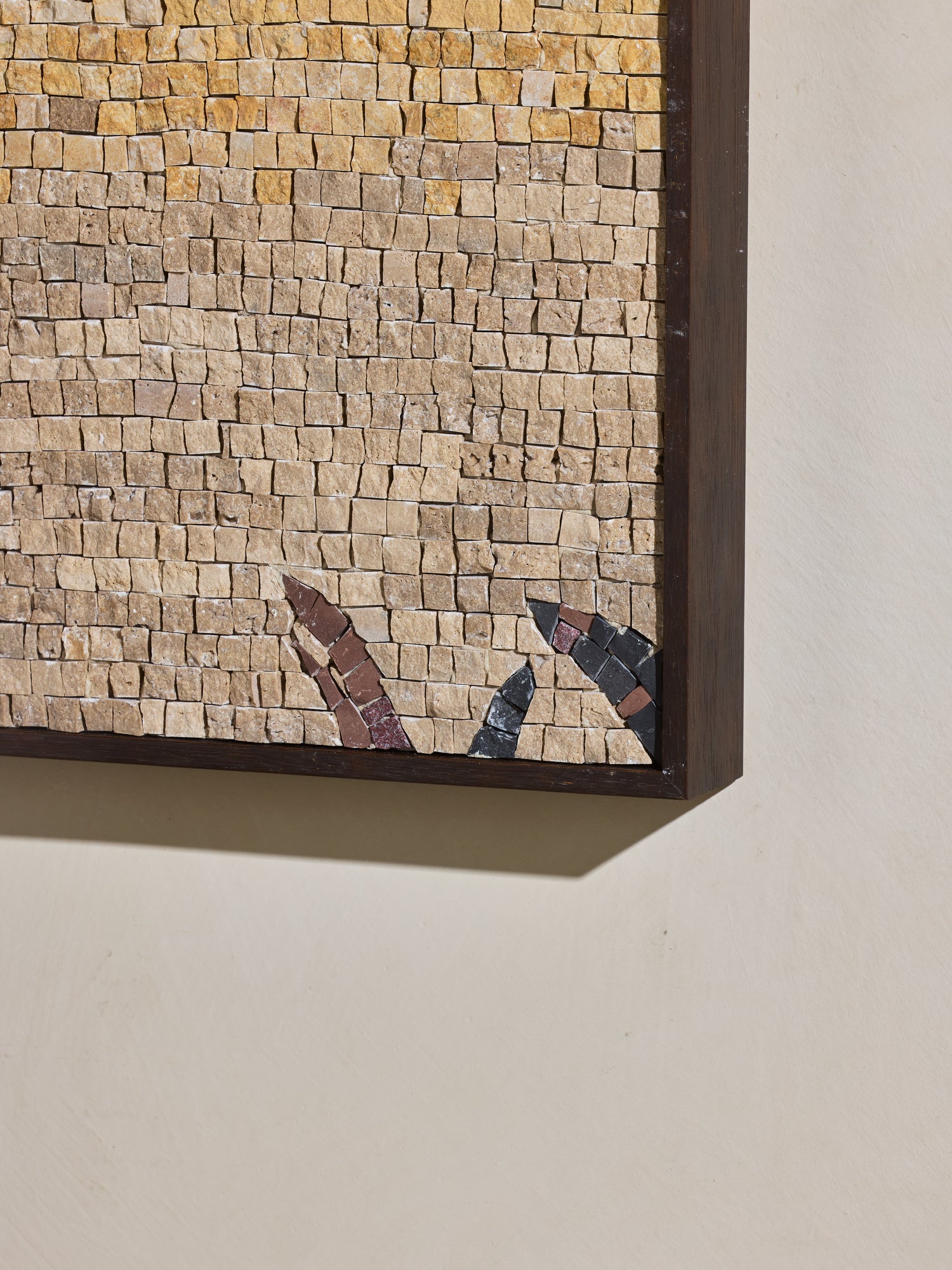 Close up of hand cut and applied stone on mosaic square stone artwork.