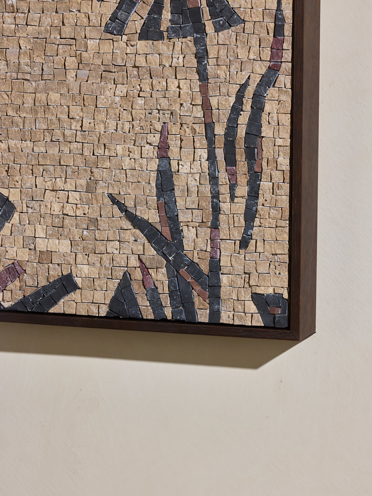 Close up of hand cut and applied stone on mosaic square stone artwork.