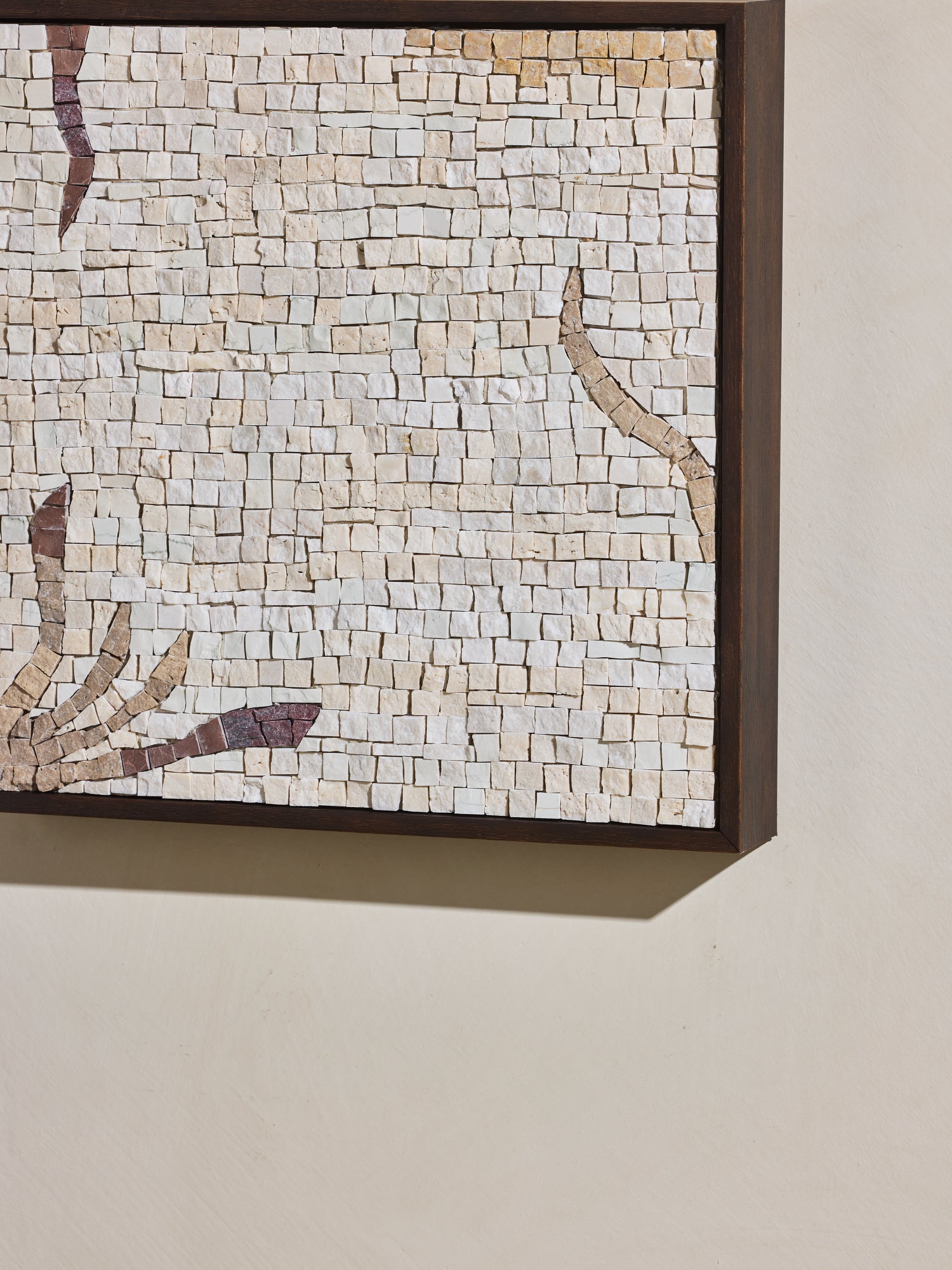 Close up of mosaic square stone art piece with off white and beige details and wooden framing.