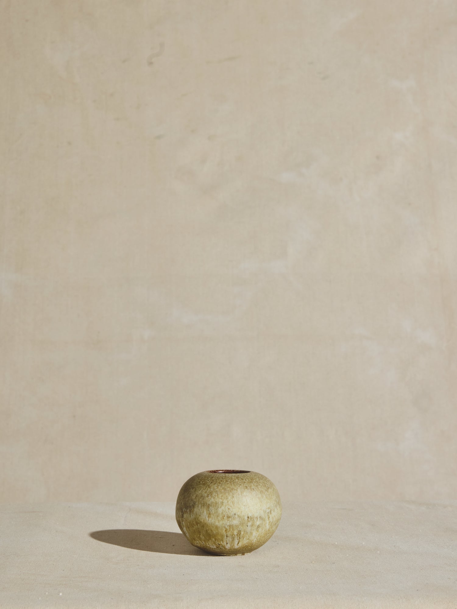 Vintage circular vessel in glazed pistachio color.