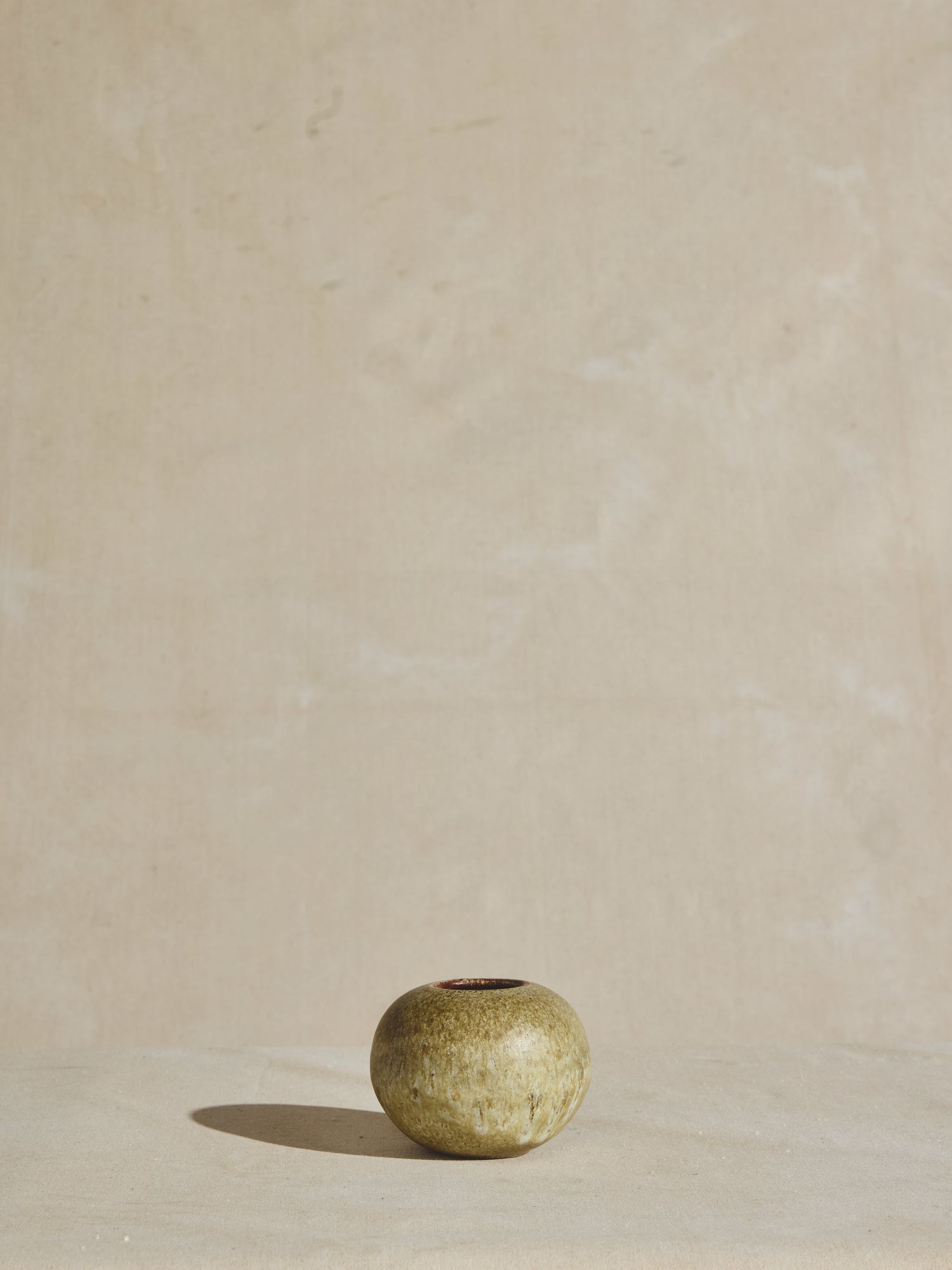 Vintage circular vessel in glazed pistachio color.