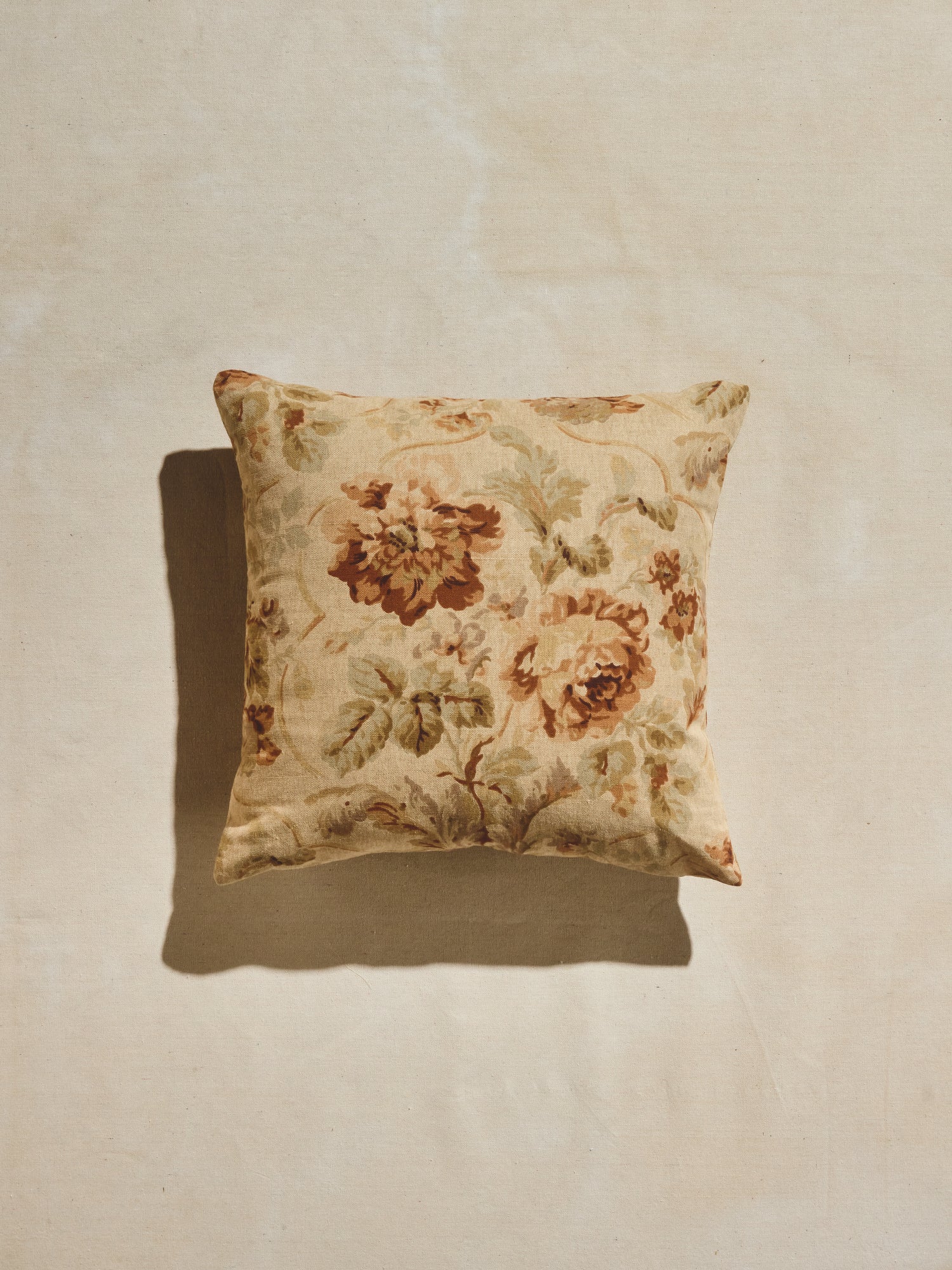 Warm pastels and rust hues floral patterned woven square pillow. 