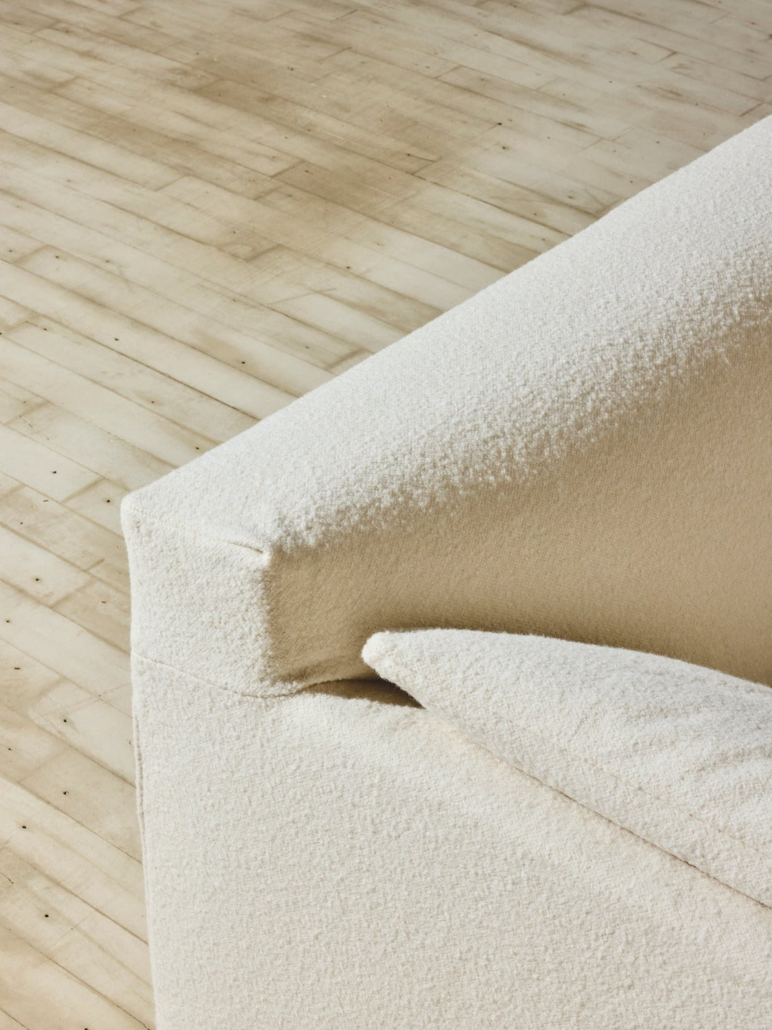 Close up of the head rest with crema slip cover on the Bromley Sofa.