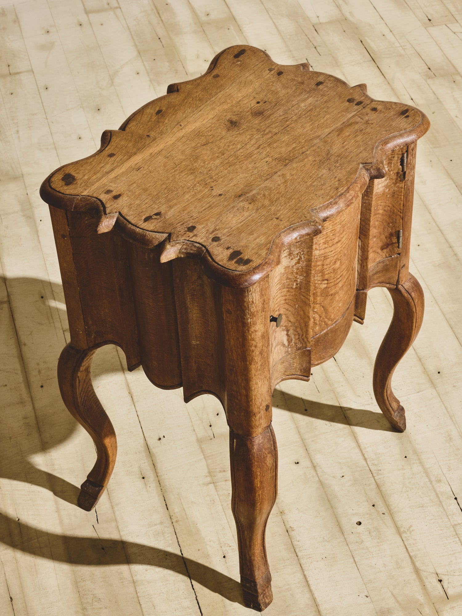 Baroque solid oak side table with fluted sides, wavy oak grain pattern, and hand sculpted XV French style legs. 