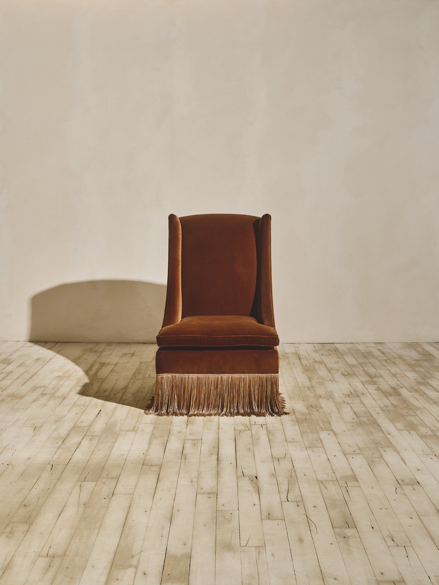 European inspired high back winged chair shown in our ochre fabric paired with our bronze fringe.