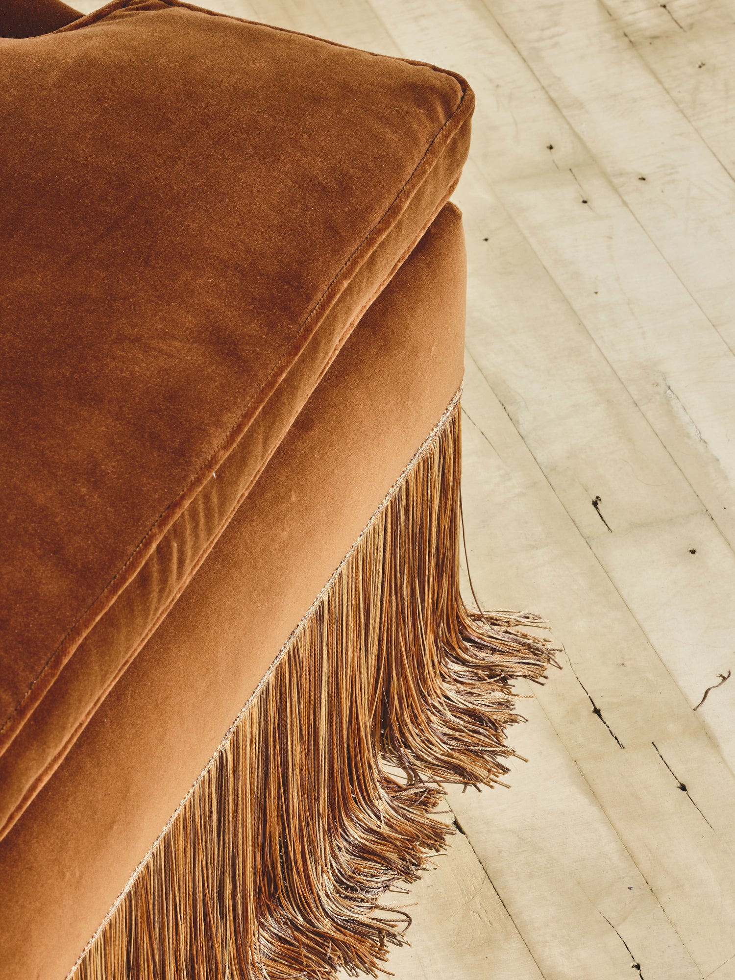 Close up of the ochre hand-pulled upholstery fabric on the high back winged chair.