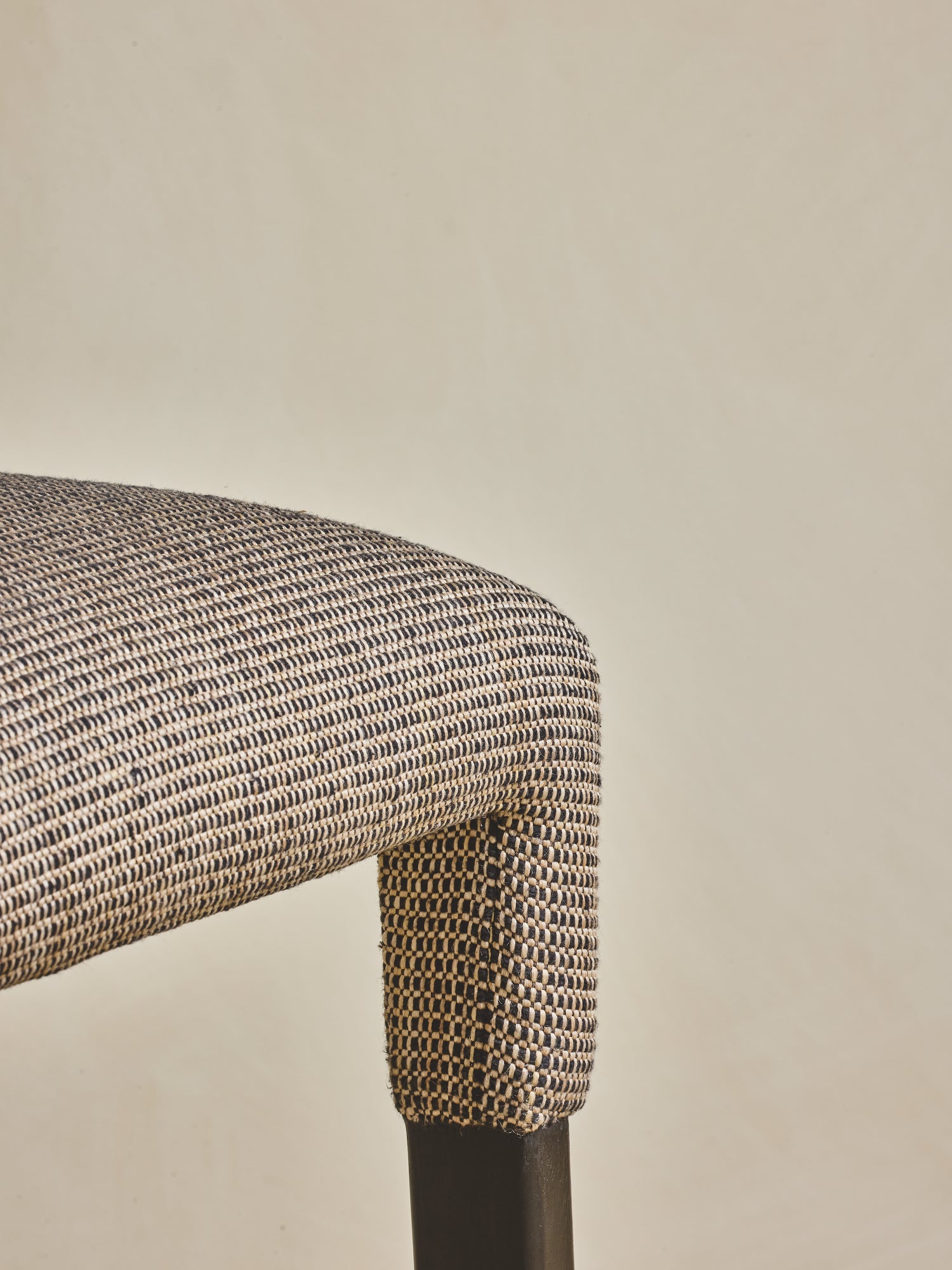 Close up of upholstered seating on the white oak Mr. Wolcott Counter Stool.