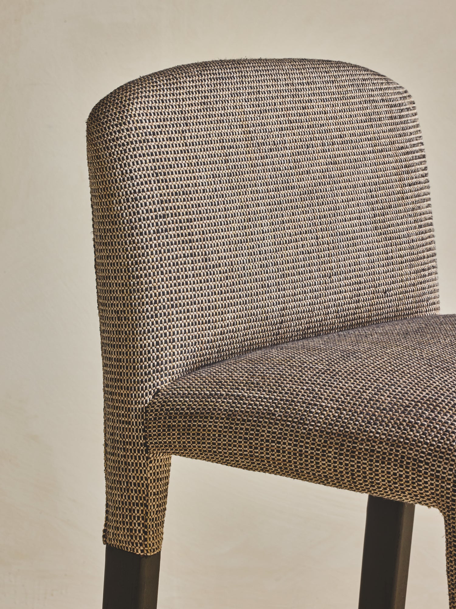 Closeup of lightly upholstered seating on the white oak Mr. Wolcott Counter Stool.