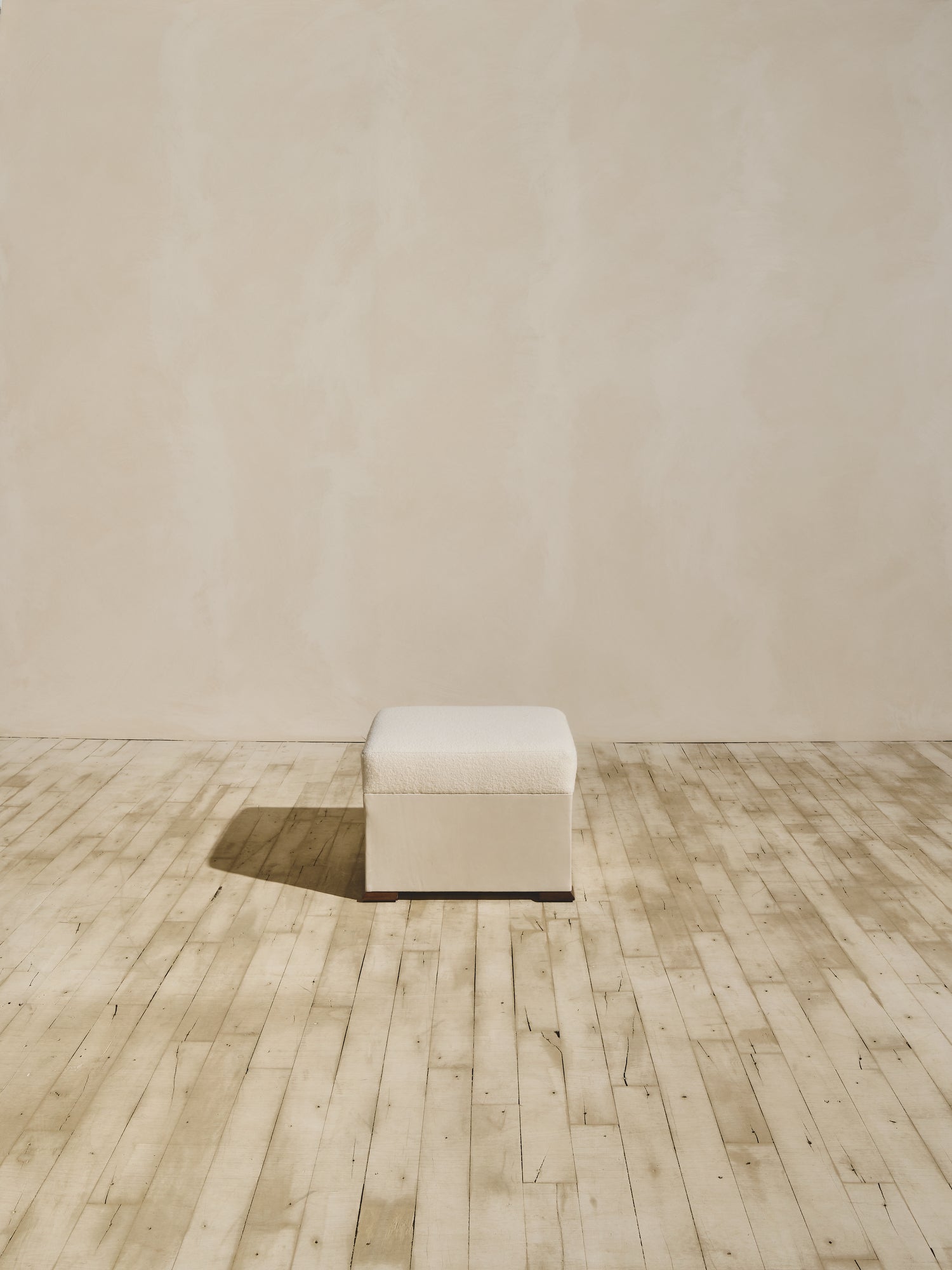 Brutalist style Bromley Ottoman in crema fabric.