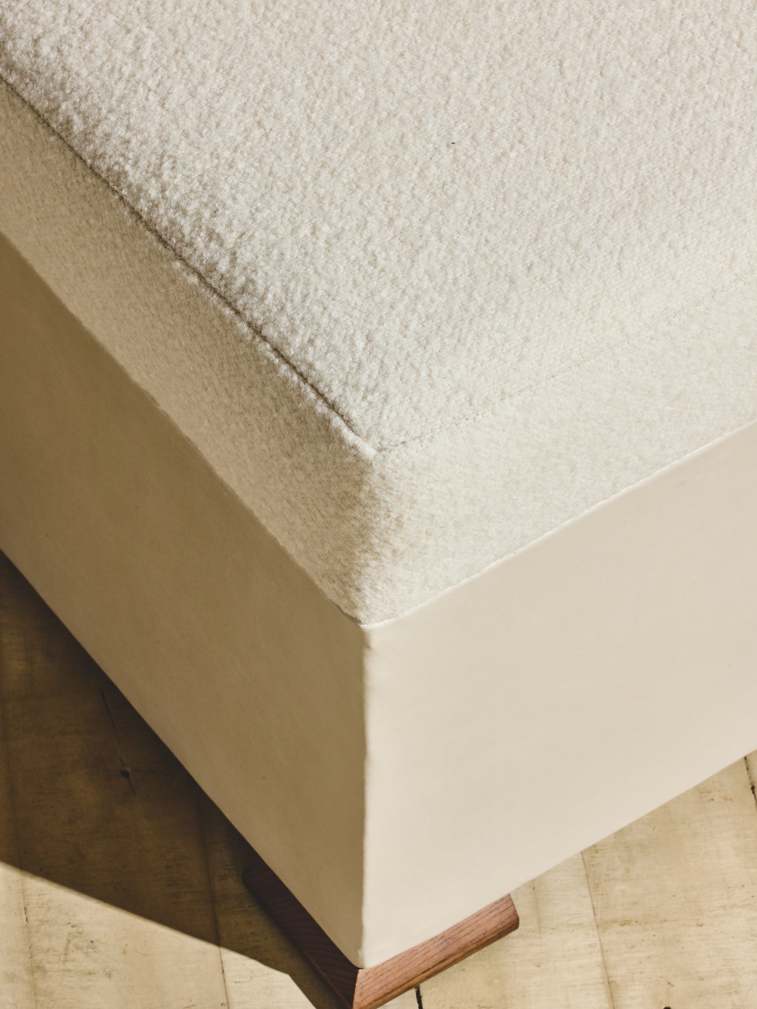 Close up of brutalist style Bromley Ottoman in crema fabric.