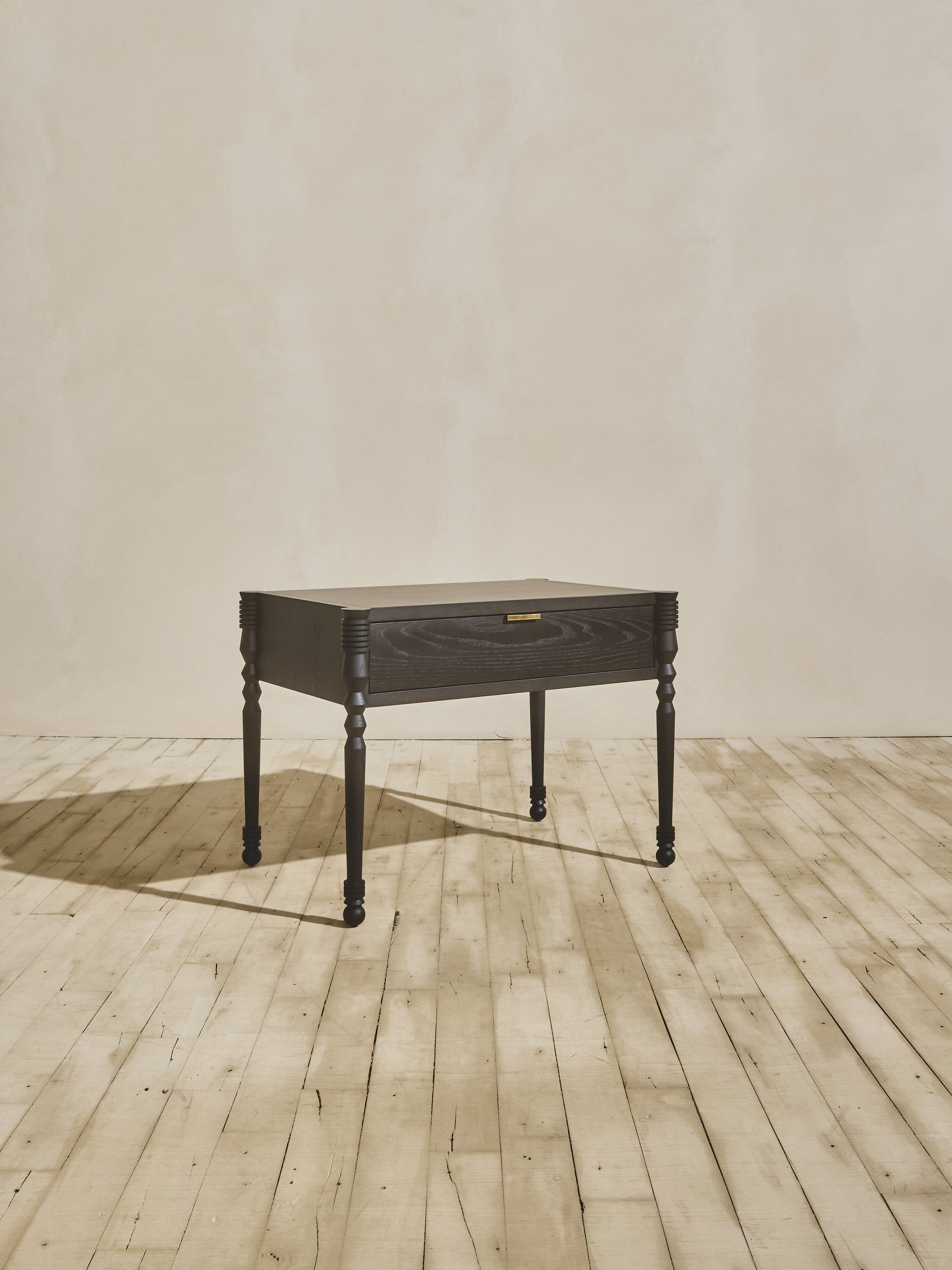 Modern style wooden Disc Side Table showcasing geometric leg turnings, in ebony finish.