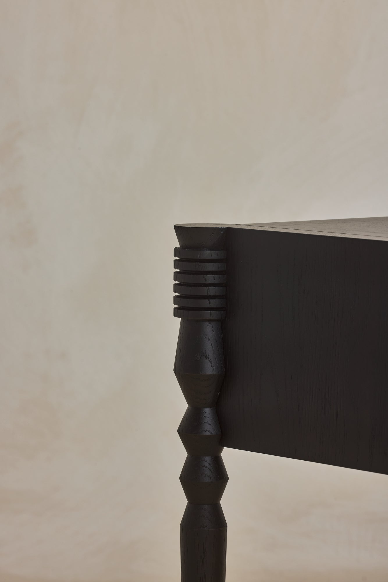 Close up of geometric leg turnings in ebony finish from Disc Side Table