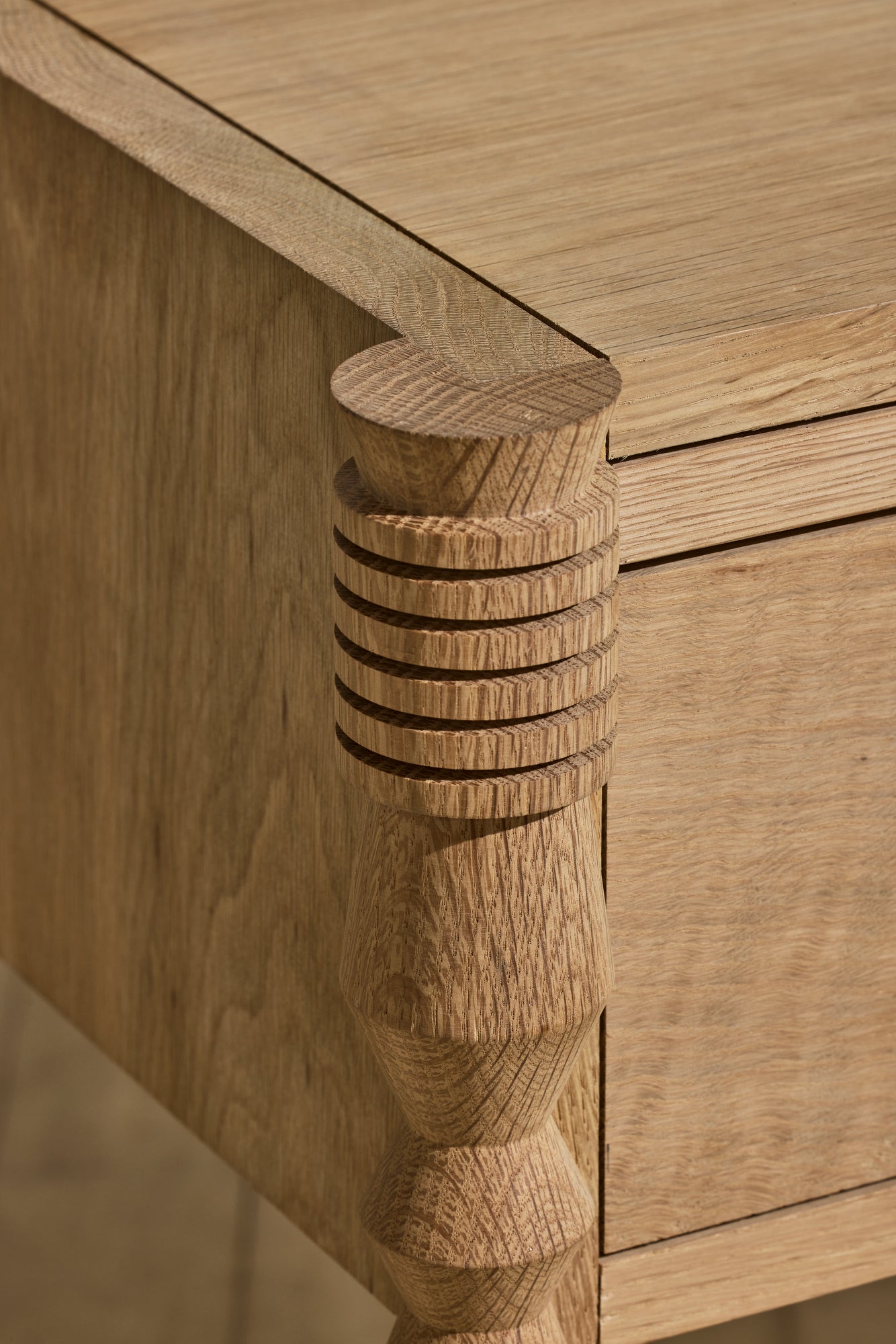 Close up of geometric leg turnings in natural finish from Disc Side Table