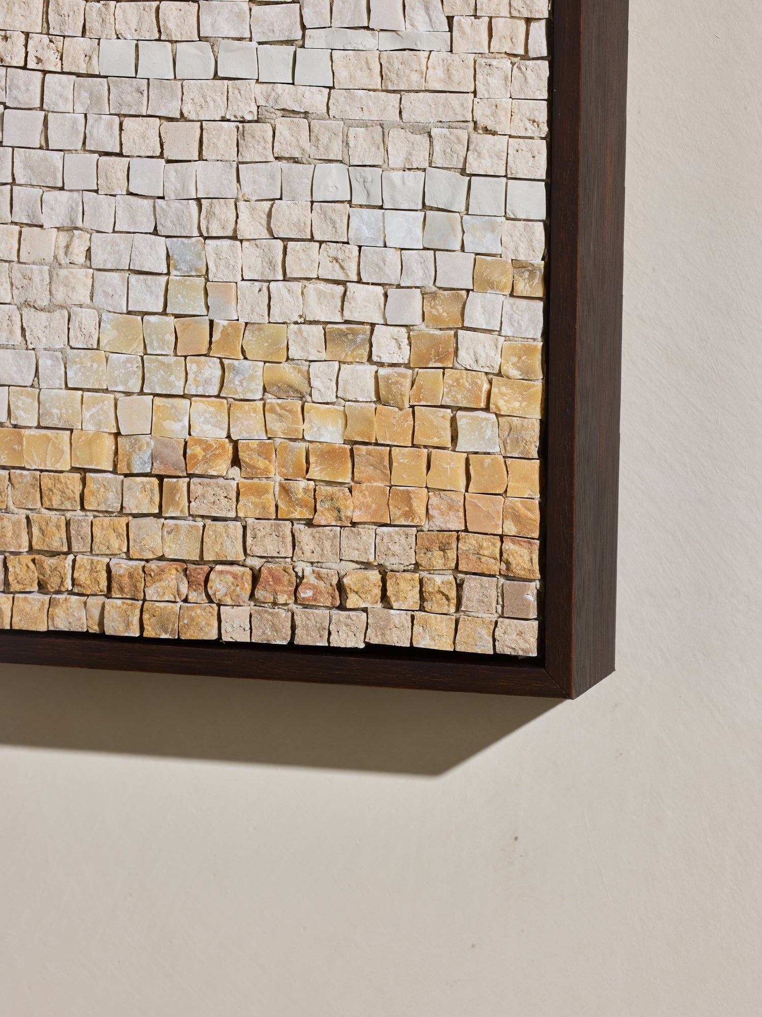 Close up of hand cut and applied stone on mosaic square stone artwork.