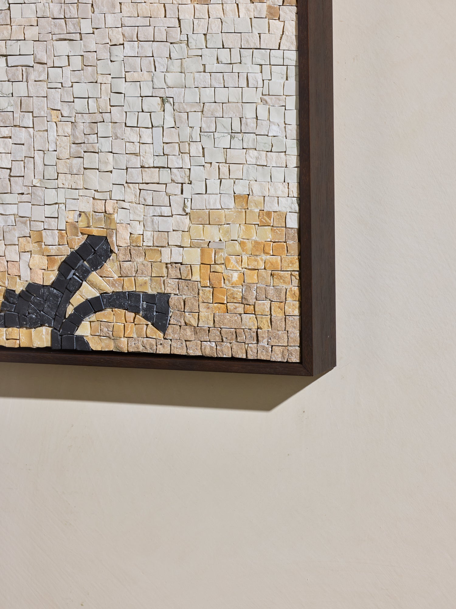 Close up of yellow and light beige hand cut and applied stone on mosaic square stone artwork.
