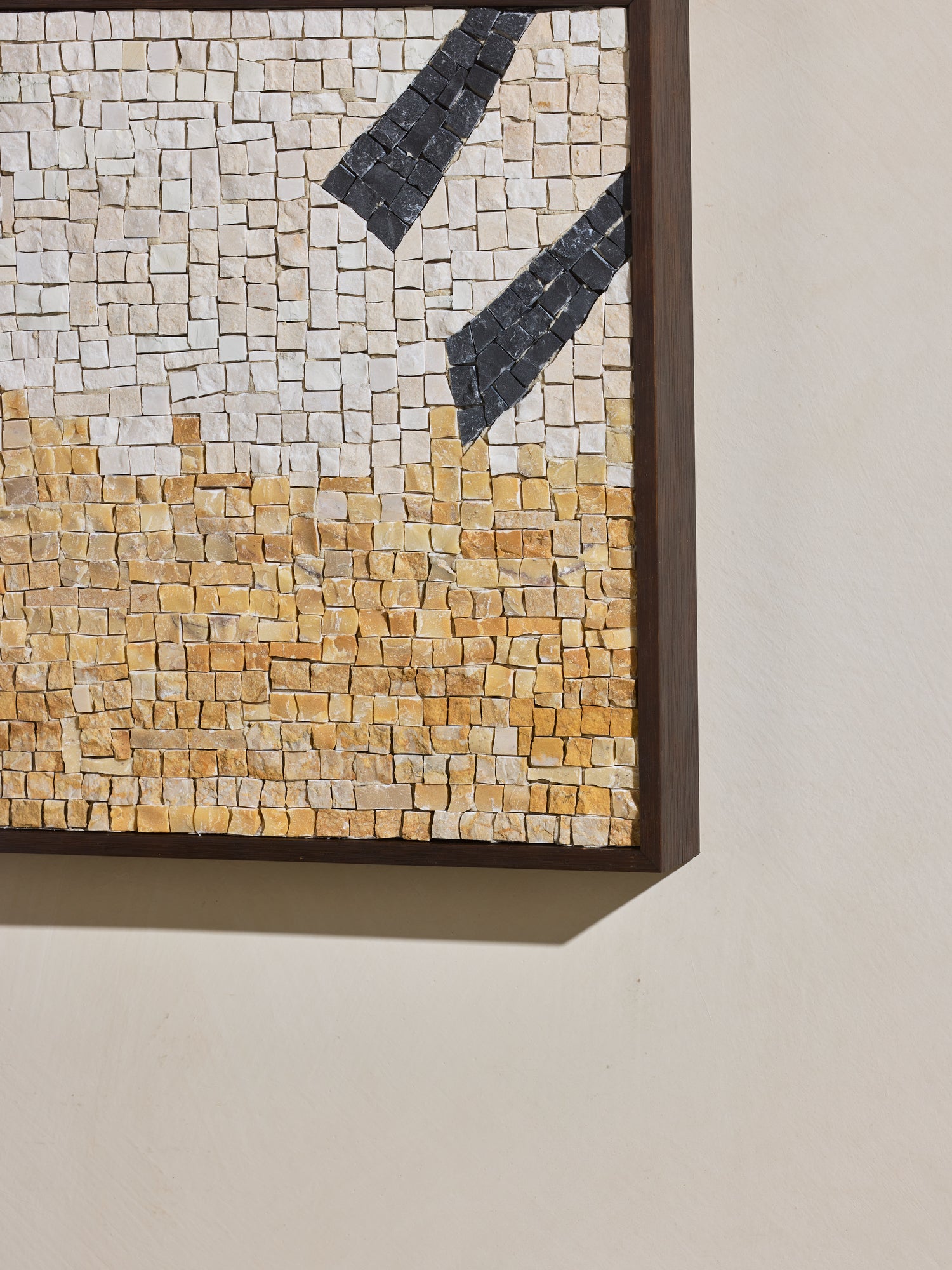 Close up of hand cut and applied stone on mosaic square stone artwork.