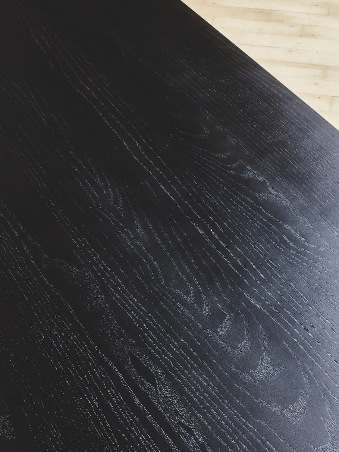Close up of the natural finish stained oak wood grain that makes the NBL Coffee Table.